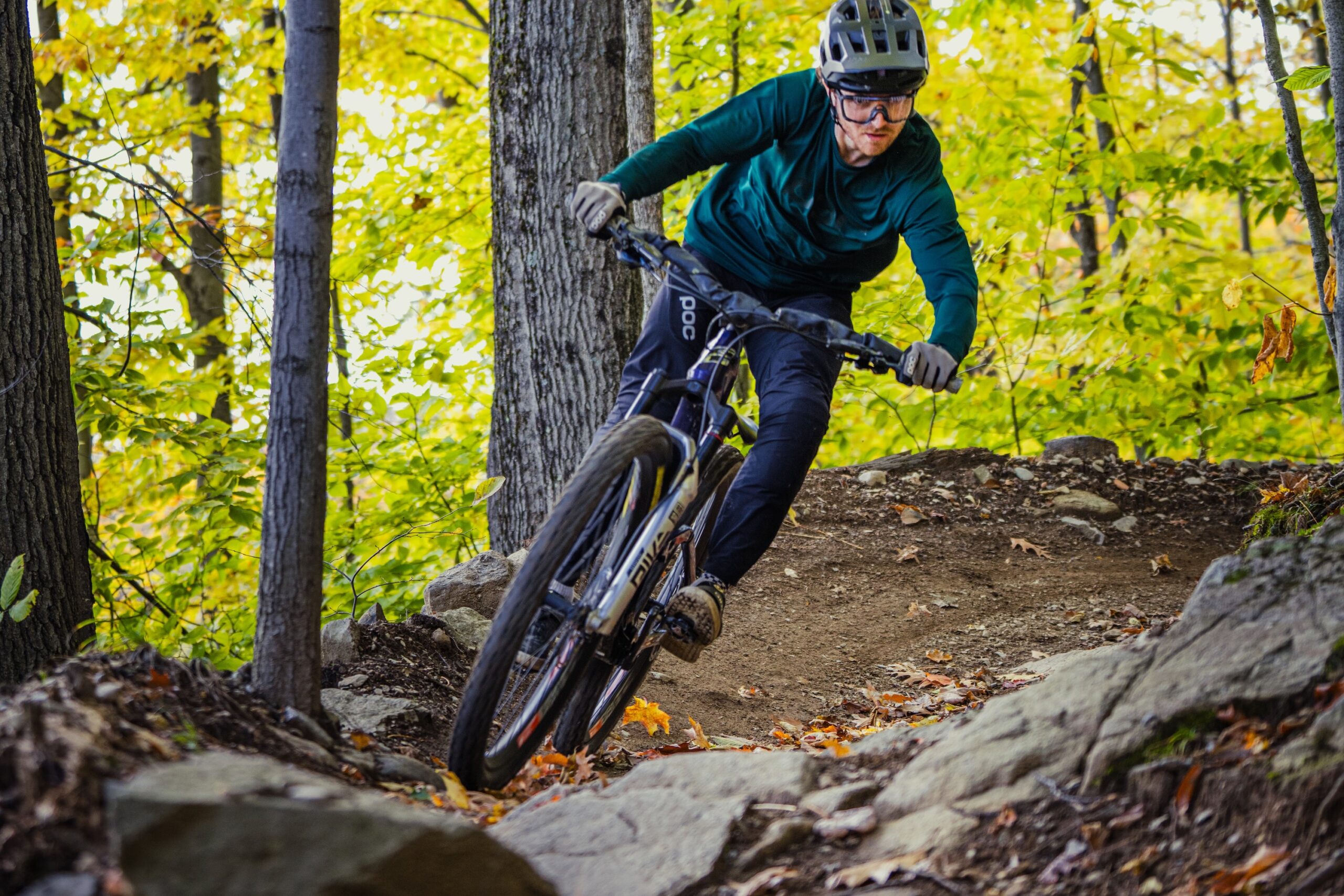 Adam Robbins riding into a a section of chunky rocks while testing handlebar compliance