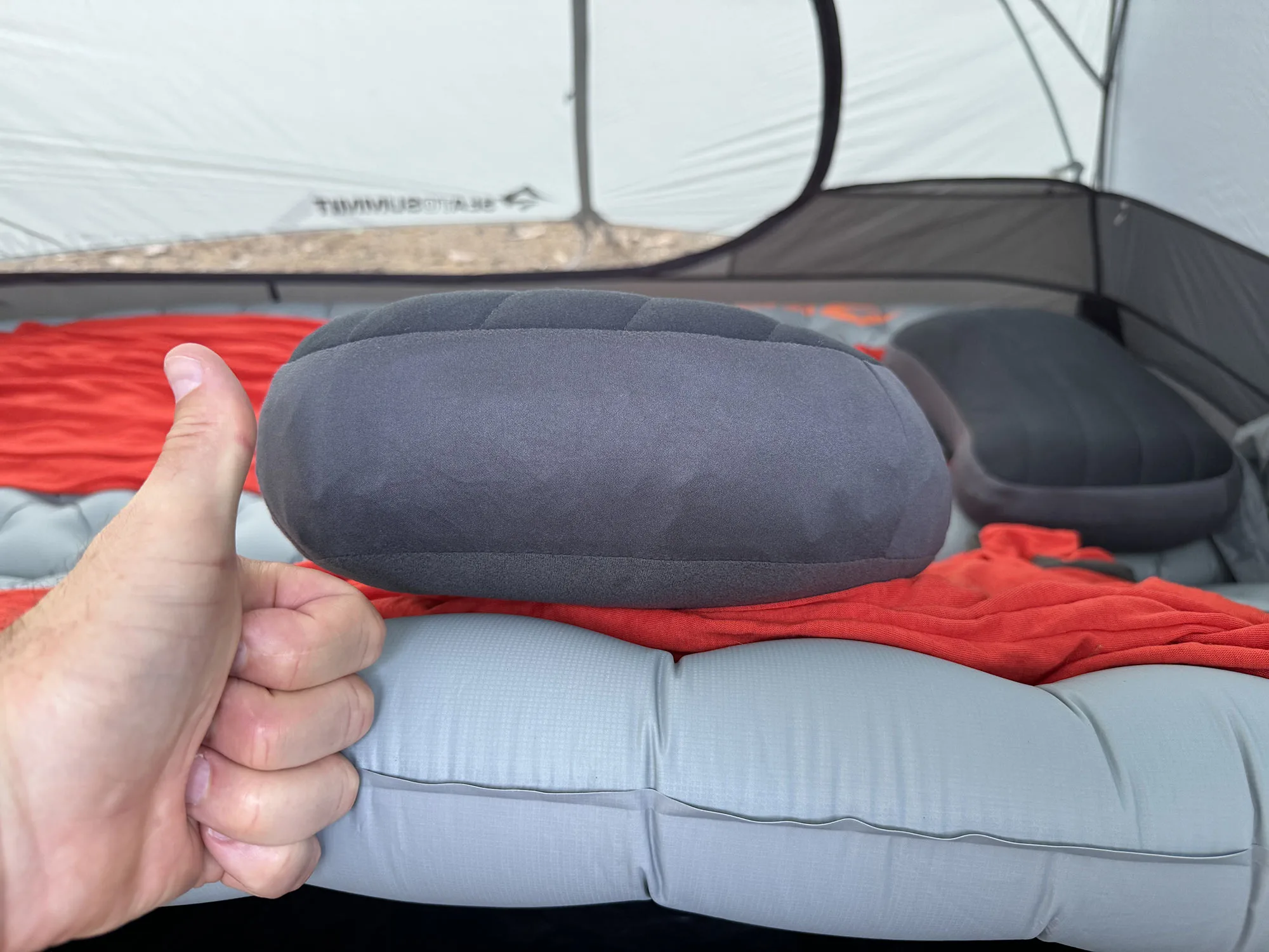 an assortment of sea to summit lightweight camping pads, liner bag, and pillow.