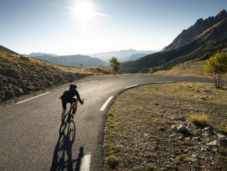 Man riding down a sunny road