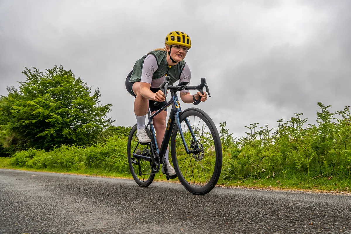 Female cyclist in green top riding the women's specific Liv Langma Advanced Pro 0 road bike