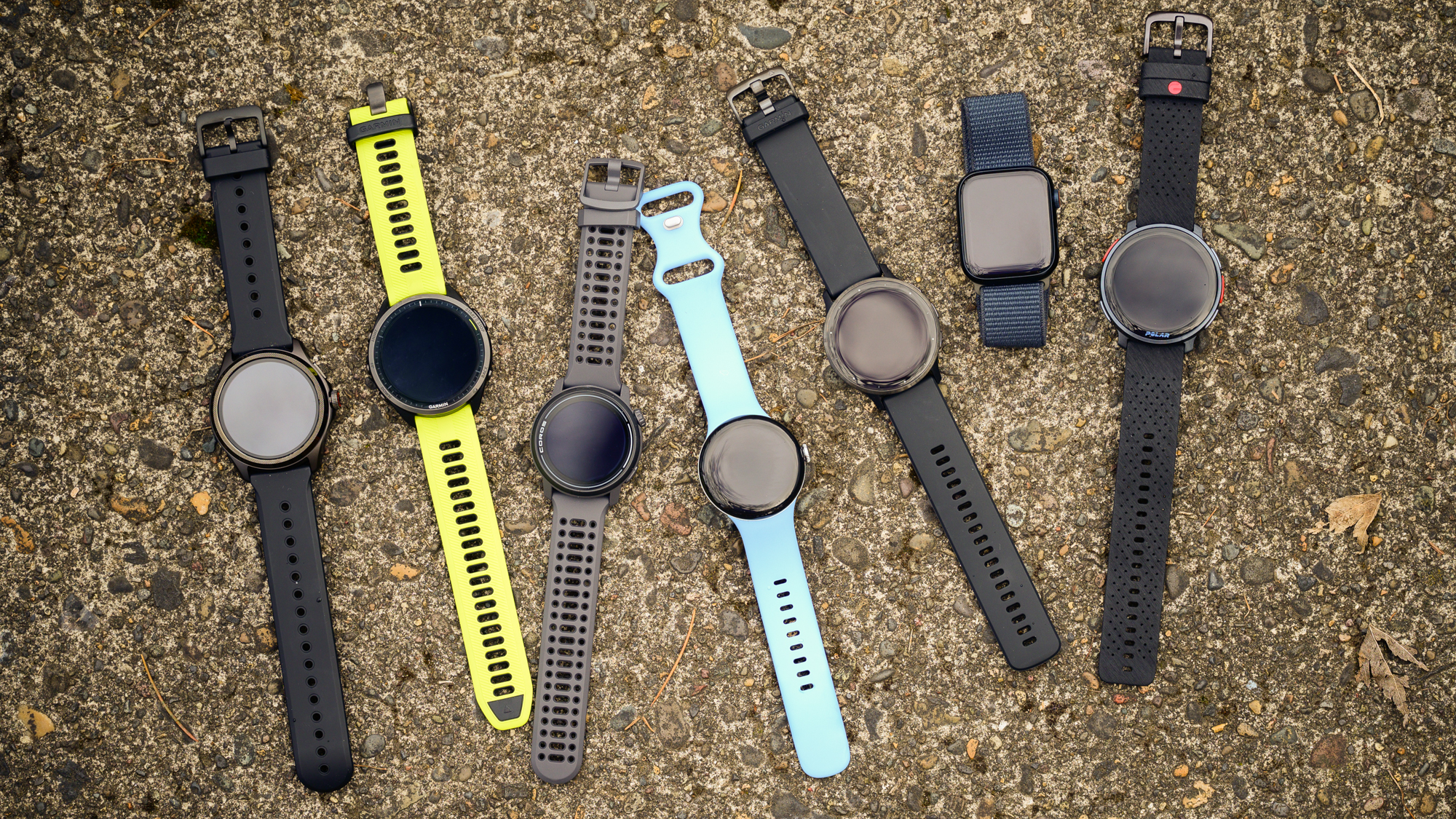A group of cycling watches on a pavement background