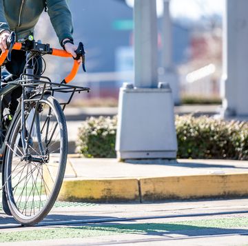 cyclist crosses tram tracks on a dedicated crossing for cyclists and pedestrians