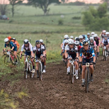 a group of cyclists on a muddy road a group of cyclists on a muddy road