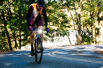 cyclist working hard while riding with light on front of bike