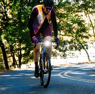 cyclist working hard while riding with light on front of bike cyclist working hard while riding with light on front of bike