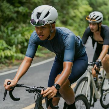 groups of cyclists riding road bikes in the morning are climbing