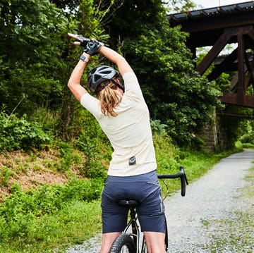 woman stretching on bike woman stretching on bike