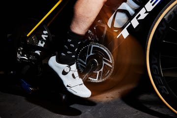 Closeup of a cyclists foot on a pedal with a stationary bike setup