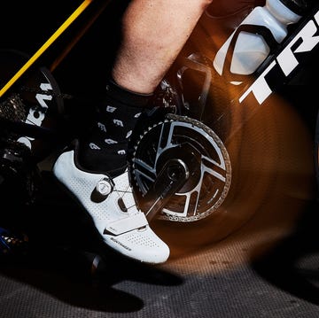 Closeup of a cyclists foot on a pedal with a stationary bike setup Closeup of a cyclists foot on a pedal with a stationary bike setup