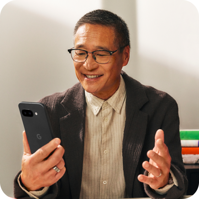 A small business owner works on his Google Pixel 9a phone.